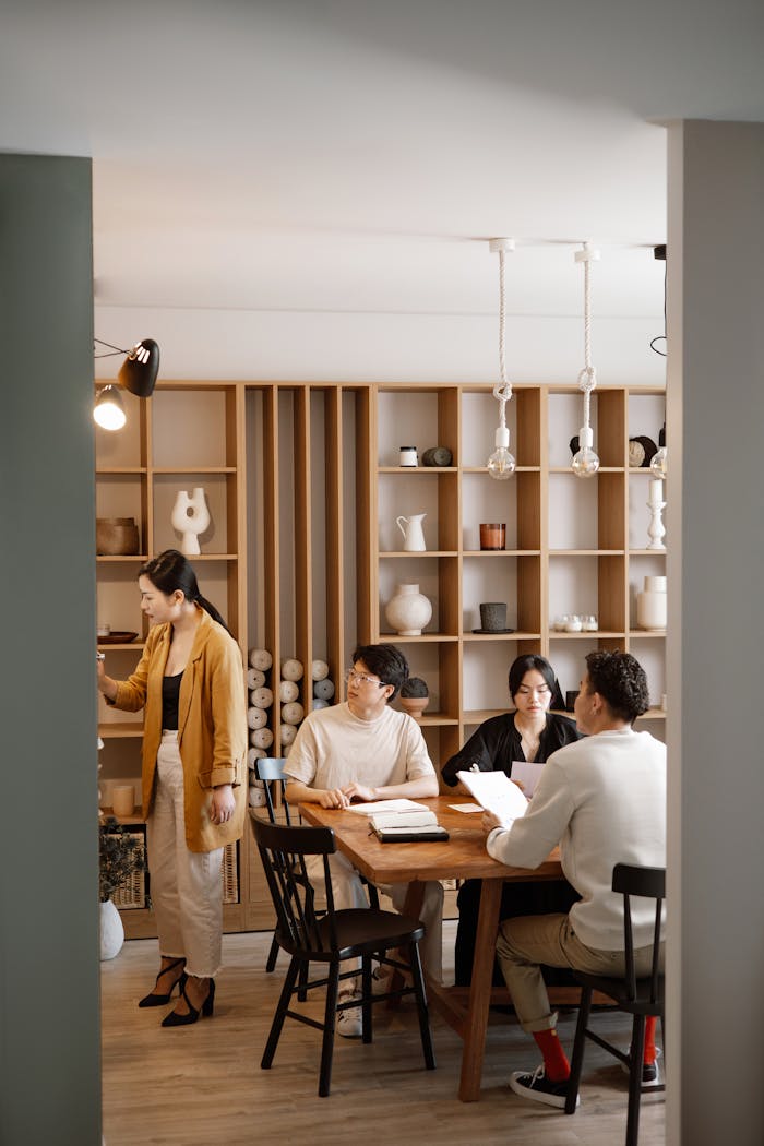 why-choose-us A diverse group of professionals having a meeting in a stylish and modern office space.